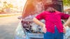 Woman dealing with overheating car