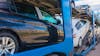 Blue semi truck transporting cars