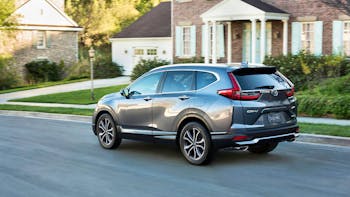 Honda CRV driving in neighborhood 