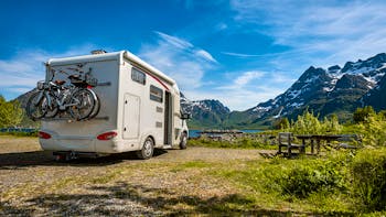 RV parked in front of a lake