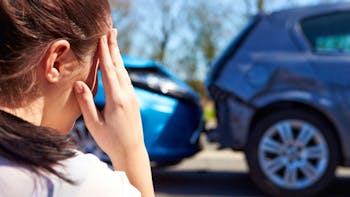 Girl in front of two collided cars
