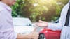 Insurance agent and customer shaking hands after the claim of contract