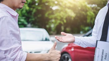 Insurance agent and customer shaking hands after the claim of contract