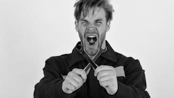 Mad mechanic holding 2 wrenches