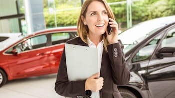 Smiling saleswoman having a phone call