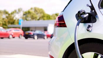 Close Up Of Power Cable Charging Electric Car Outdoors