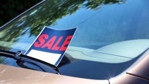 For sale sign on windshield of car