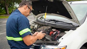 technician diagnosing a car