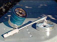 You'll need some type of oil-filter wrench; here are two sizes of socket-style cap wrenches -- one fitted to an oil filter and the other to a 3/8-inch-drive breaker bar handle.