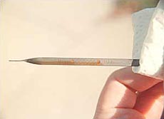 The dipstick shows the engine's oil level; the MIN marking means the oil is at the minimum operating level and is one quart low.