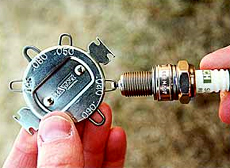 A special gauge/tool is used to measure the spark plug gap and, if necessary, to bend the electrode to achieve the correct specification.