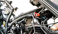 Automakers have gotten better in recent years about labeling or color-coding dipsticks. The ring on the right is red to match the automatic transmission fluid, the level of which this dipstick measures. The yellow ring is clearly marked "engine oil."