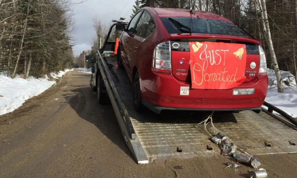 Car being towed away for donation to NPR station